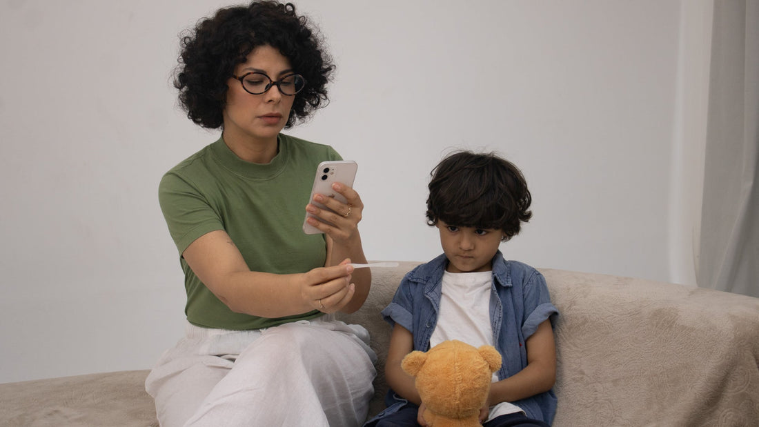 Mom checking child's temperature via app on cellphone