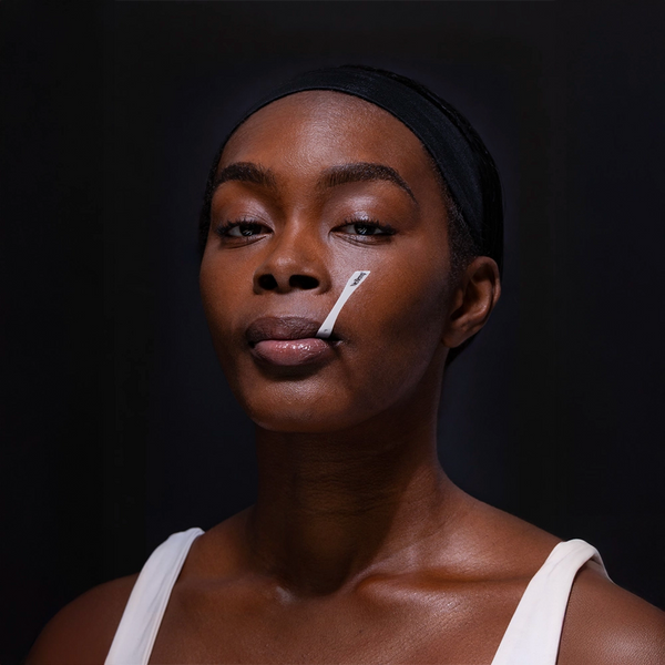 Athlete Holding NexTemp Disposable Thermometer Under Lip for Temperature Reading