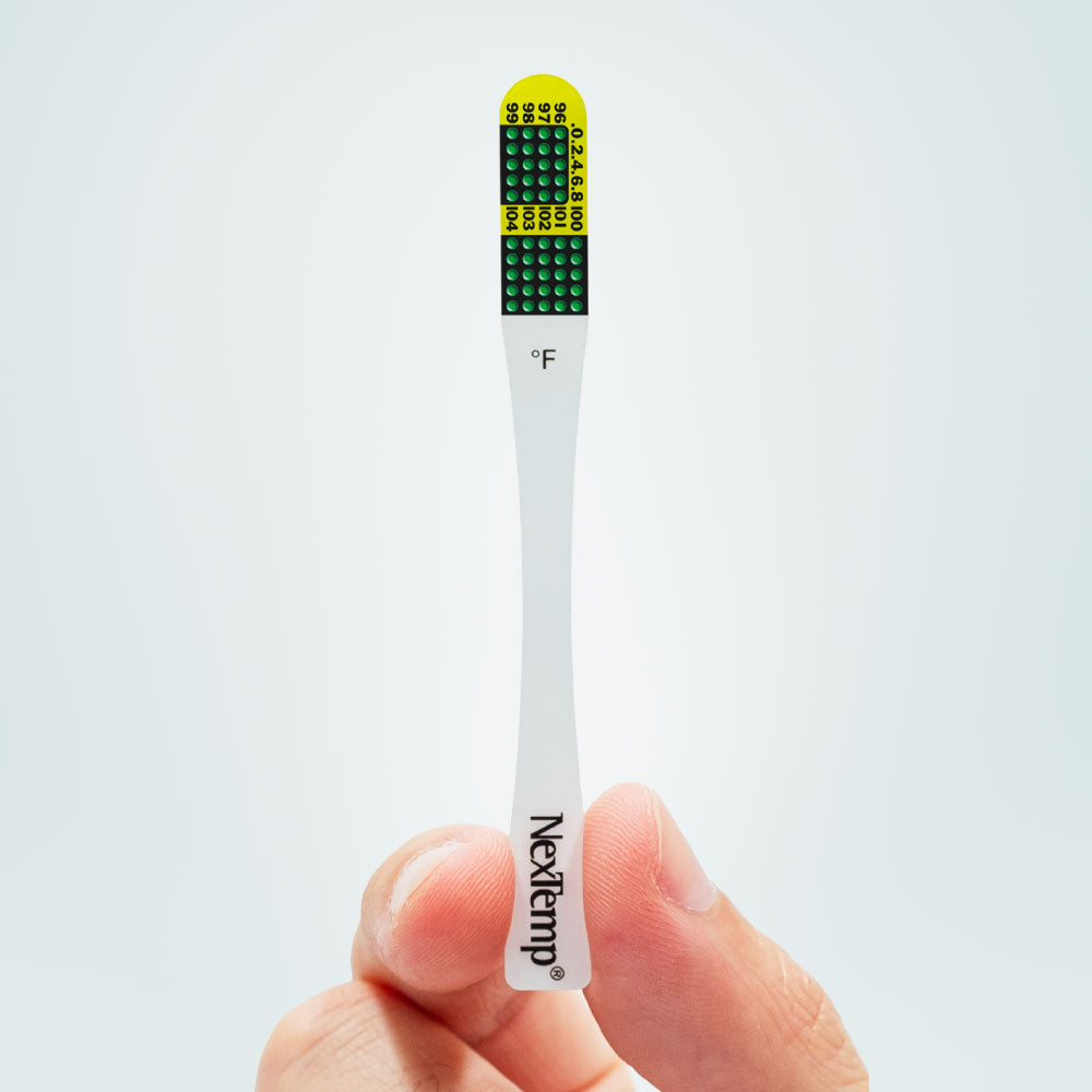 Hand Holding NexTemp Ultra Disposable Thermometer