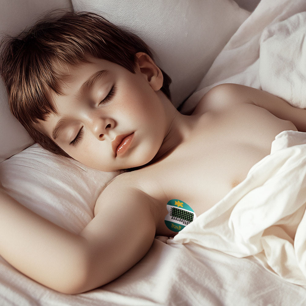 Sleeping child wearing a TraxIt wearable underarm thermometer for continuous fever monitoring
