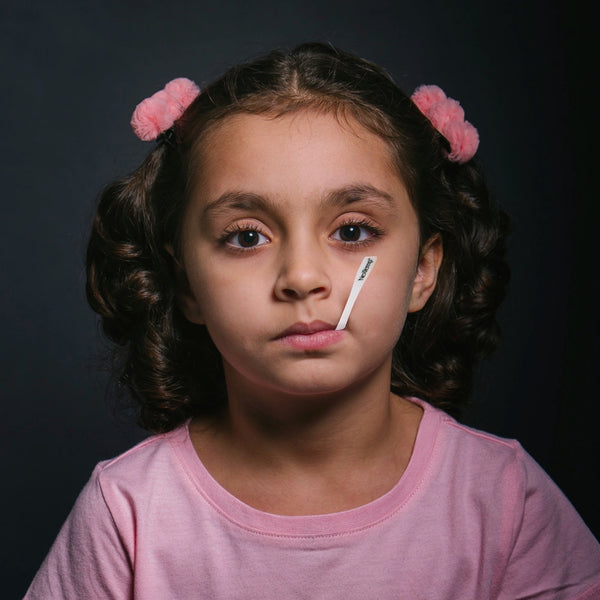 Young Kid Using NexTemp Disposable Thermometer Under Lip for Fever Monitoring